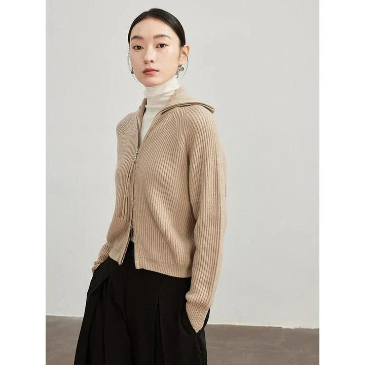 A woman wearing a heavy wool cardigan in a khaki color, showcasing the elegant and cozy design.