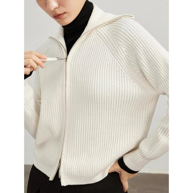 A woman wearing a heavy wool cardigan in a khaki color, showcasing the elegant and cozy design.