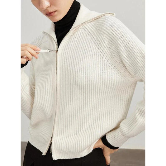 A woman wearing a heavy wool cardigan in a khaki color, showcasing the elegant and cozy design.