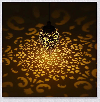 Decorative, solar-powered metal lantern for hanging in outdoor gardens, patios, and backyards