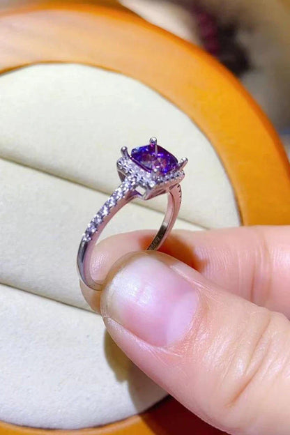 Close-up of a 1 carat moissanite ring with a platinum-plated square setting