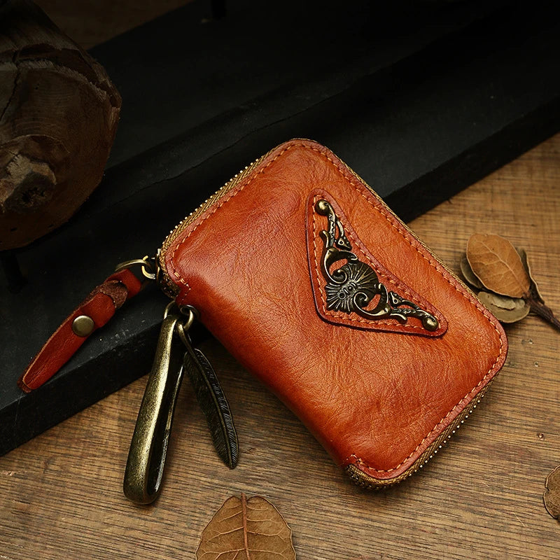Handmade cowhide leather key bag with a heart-shaped design, available in black, brown, and light brown colors