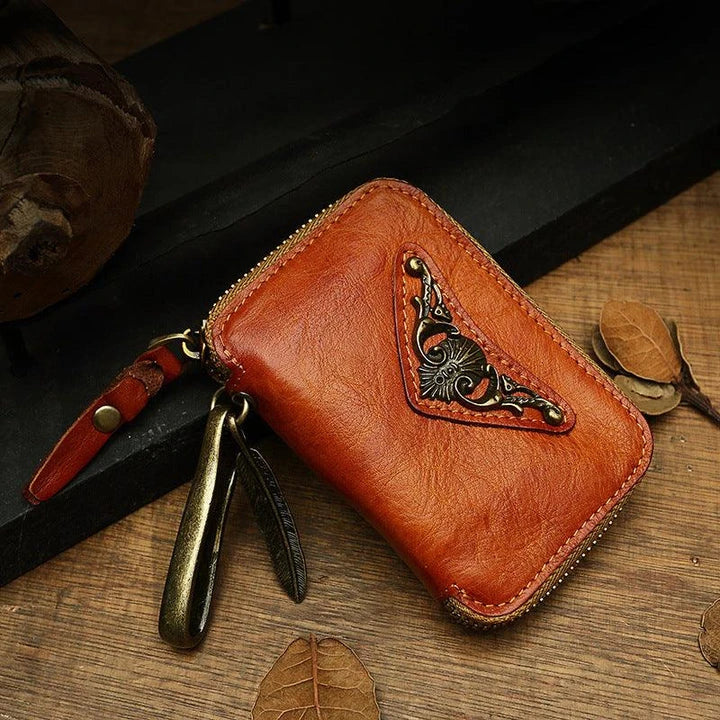 Handmade cowhide leather key bag with a heart-shaped design, available in black, brown, and light brown colors