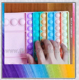 Pop Bubble Fidget Toy in various vibrant colors and shapes, perfect for stress relief, skill development, and competitive gameplay