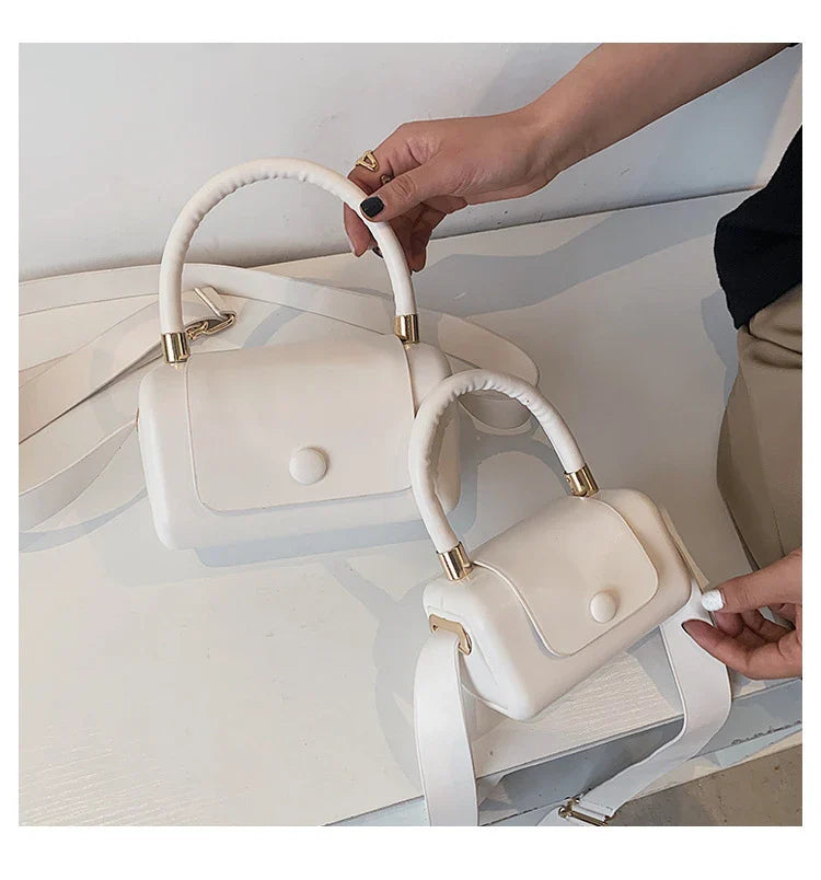 Fashionable portable square bag in various colors with a compact, minimalist design for everyday use