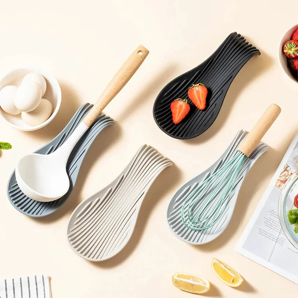 A modern and stylish silicone kitchen utensil mat in a gray color, designed to keep your countertops clean and organized while protecting them from hot utensils.