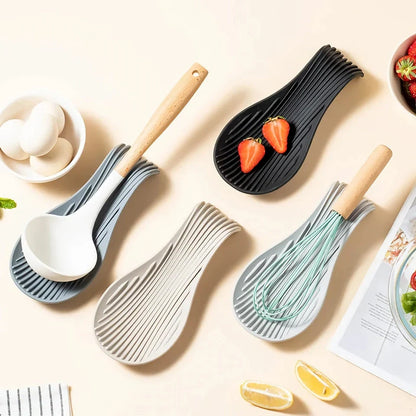 A modern and stylish silicone kitchen utensil mat in a gray color, designed to keep your countertops clean and organized while protecting them from hot utensils.