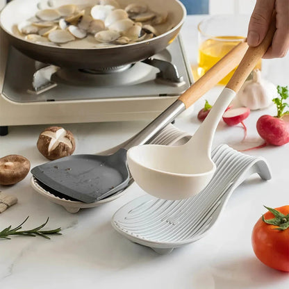 A modern and stylish silicone kitchen utensil mat in a gray color, designed to keep your countertops clean and organized while protecting them from hot utensils.