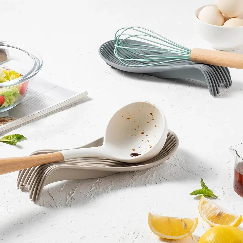 A modern and stylish silicone kitchen utensil mat in a gray color, designed to keep your countertops clean and organized while protecting them from hot utensils.