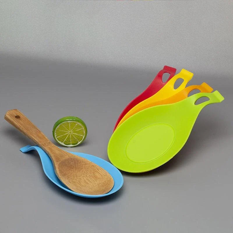 Heat-resistant silicone spoon mats in various colors protecting a kitchen counter from hot cookware