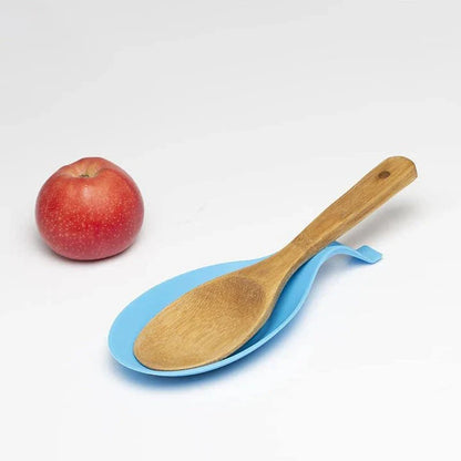 Heat-resistant silicone spoon mats in various colors protecting a kitchen counter from hot cookware