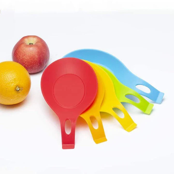 Heat-resistant silicone spoon mats in various colors protecting a kitchen counter from hot cookware