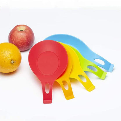 Heat-resistant silicone spoon mats in various colors protecting a kitchen counter from hot cookware