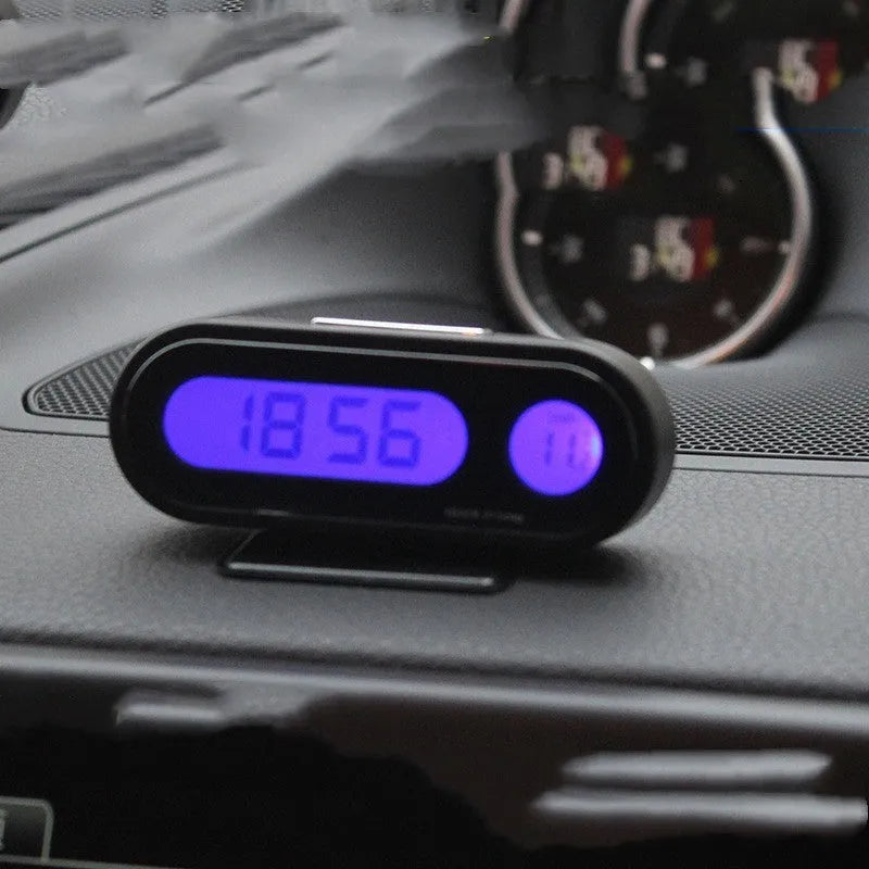 Black electronic car clock thermometer with LED display showing time and temperature, mounted on adjustable bracket