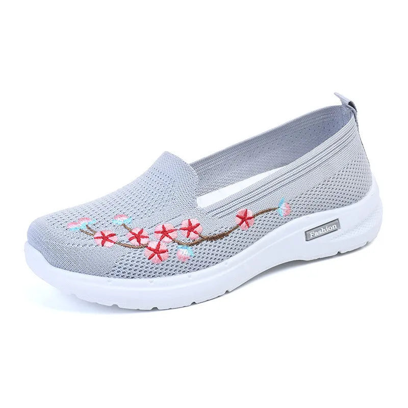 Women's low-top embroidered fly knit sports pumps in wine red with anti-slip sole.