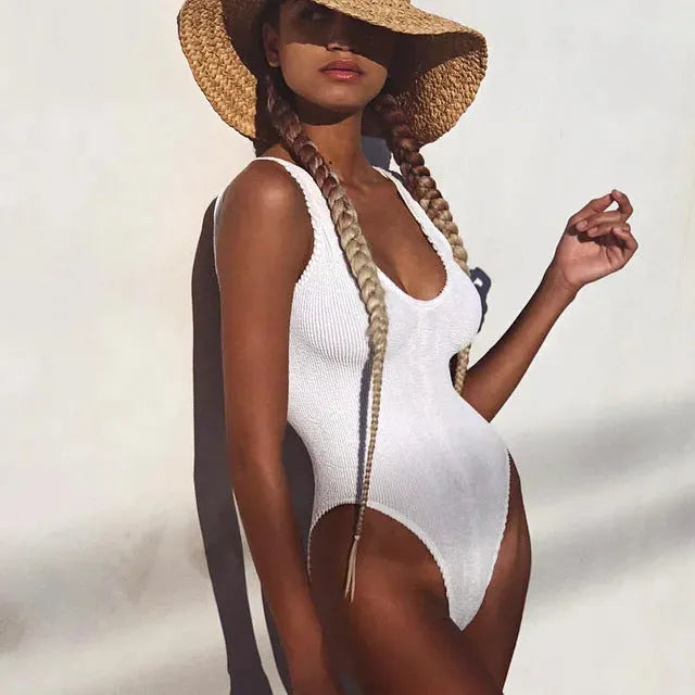 Solid colour seersucker fabric women's one-piece swimsuit with backless sleeveless design.