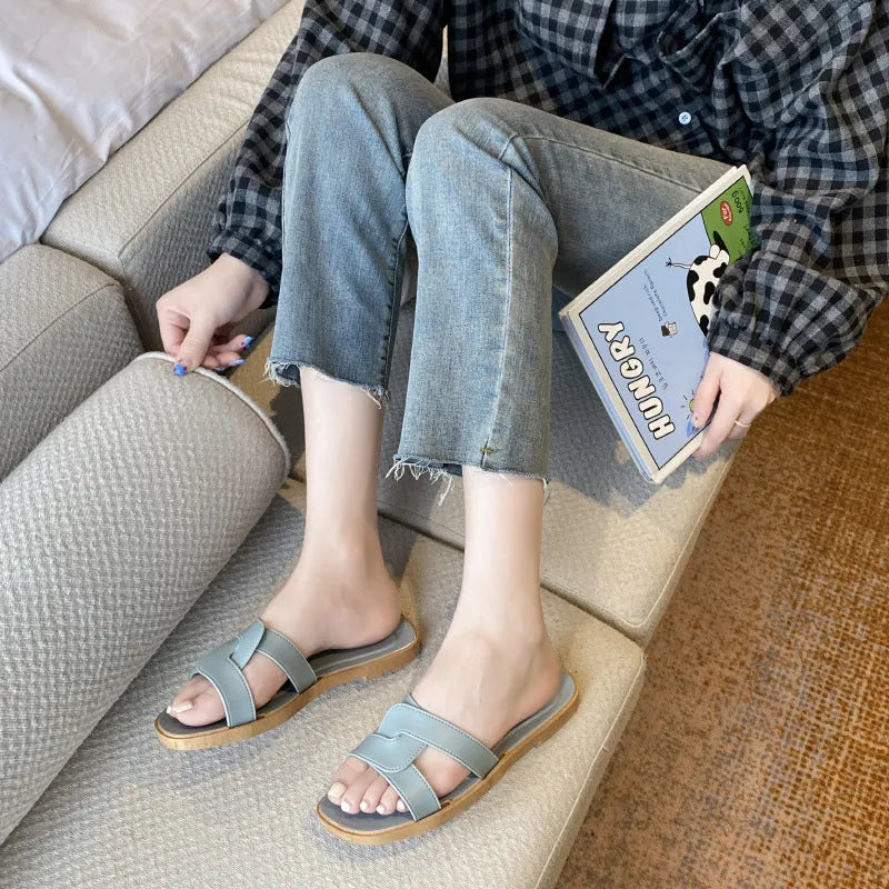 Women's PVC toe ring slippers with a cross strap in milky white, shown from a side angle.