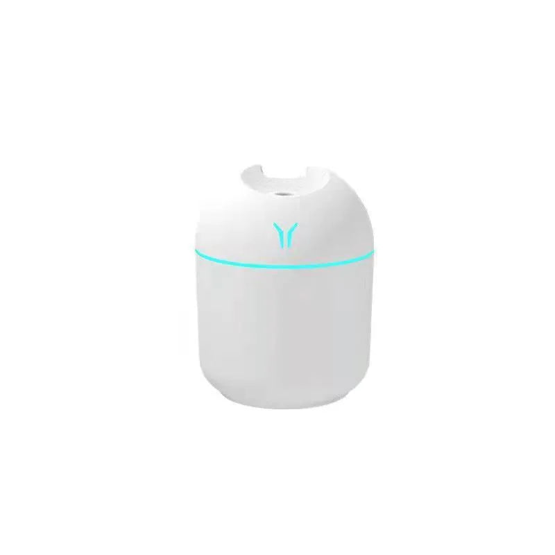 Mini round aromatherapy diffuser in ivory white with USB cable and essential oil bottle