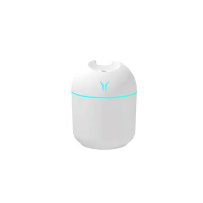 Mini round aromatherapy diffuser in ivory white with USB cable and essential oil bottle