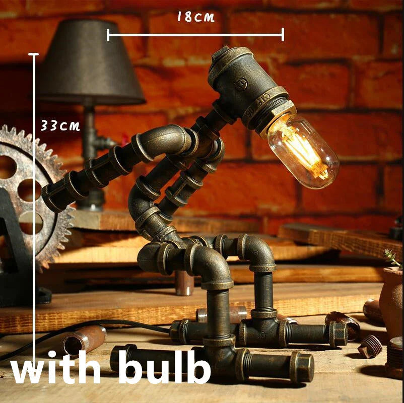 Vintage industrial iron pipe table lamp with soft, warm lighting and a green bronze finish