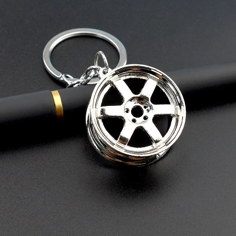 Zinc alloy car wheel hub keychain in black, gold and silver colour options