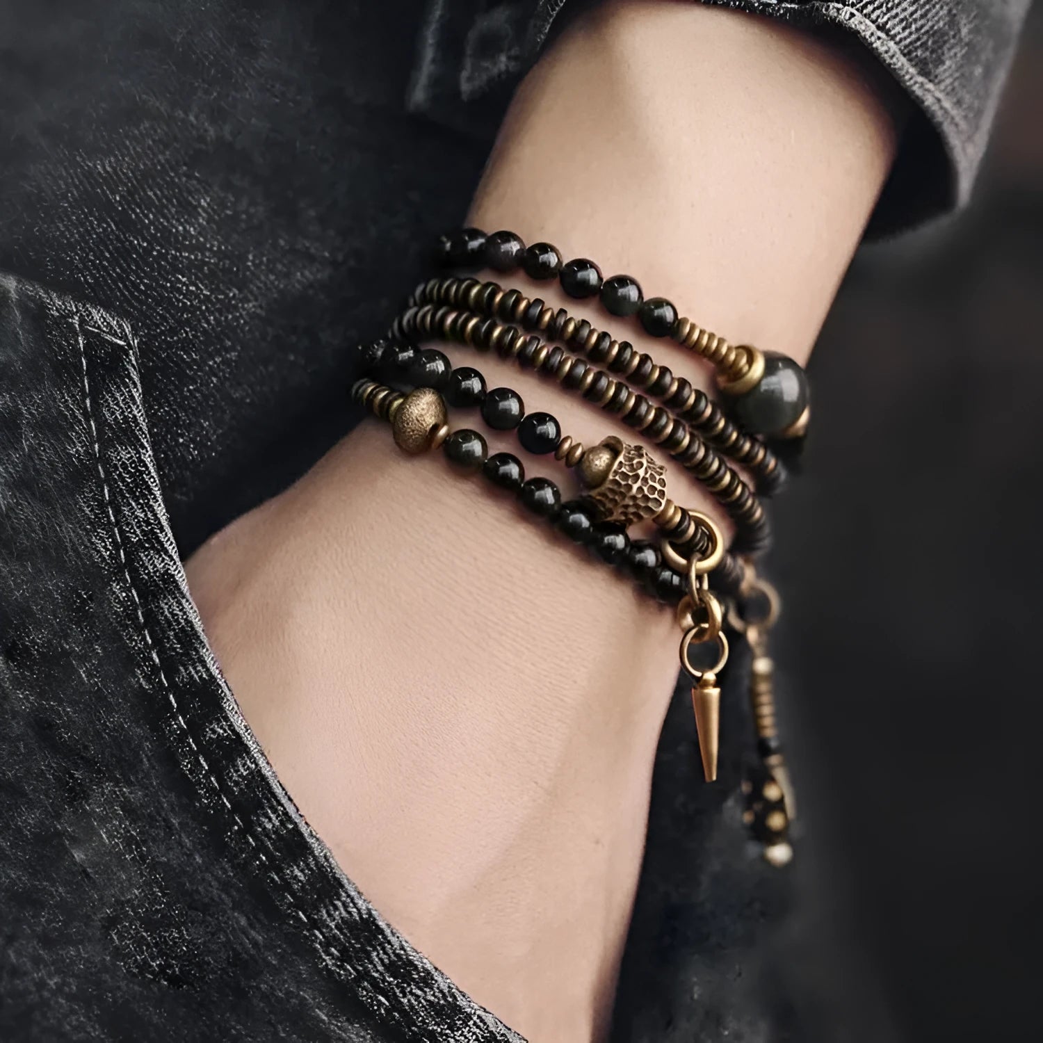 Black geometric layered beaded bracelet shown on a wrist.