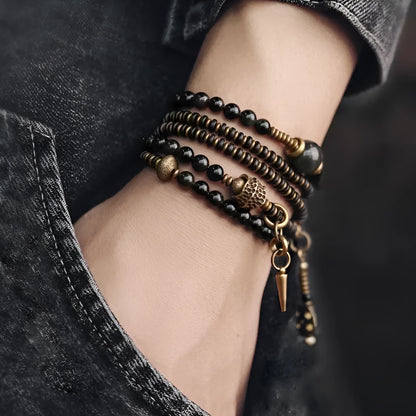 Black geometric layered beaded bracelet shown on a wrist.