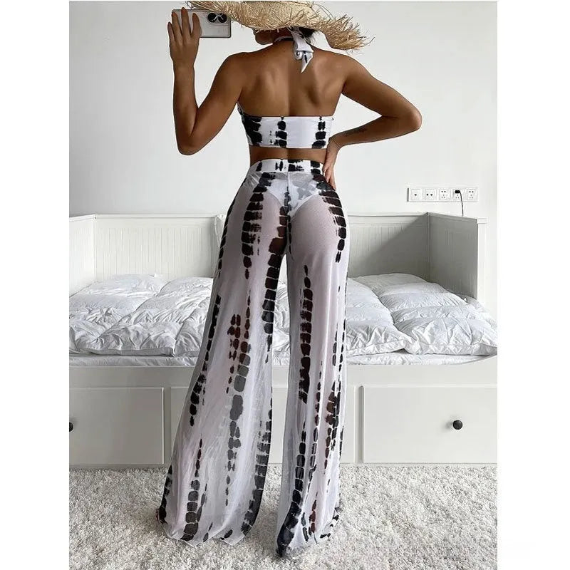 Women's black and blue printed three-piece bikini set with mesh trousers for swimming and fitness.