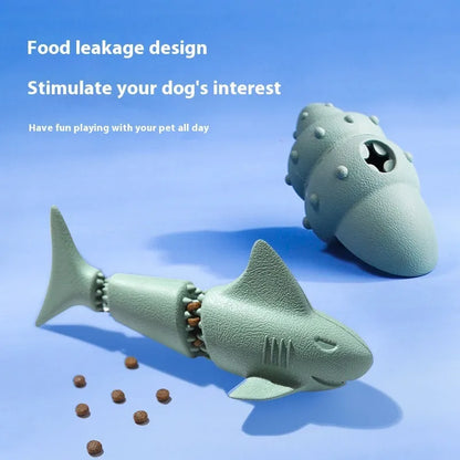 Blue rubber shark-shaped dog toy with food dispensing openings on a white background.