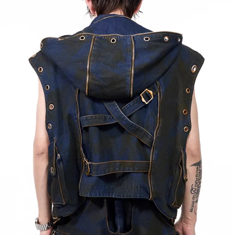 Blue hooded denim vest coat with front zip worn with matching trousers in a two-piece set.