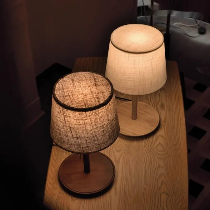 Walnut solid wood bedside lamp with fabric lampshade on wooden surface