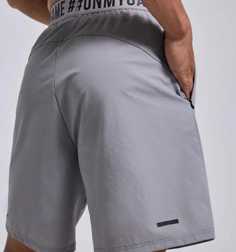 Men's sports shorts loose workout cropped pants in breathable nylon polyester blend with elastic waistband, available in black, blue, and grey colours for sports and leisure activities in Asian sizes M, L, XL, 2XL.