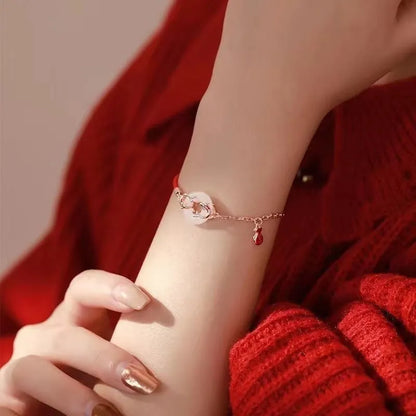 Women's festive koi bracelet with peace buckle in red rope design showing fishtail details