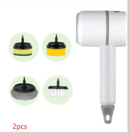 Green electric cleaning brush with scouring pad and brush heads on a kitchen worktop.