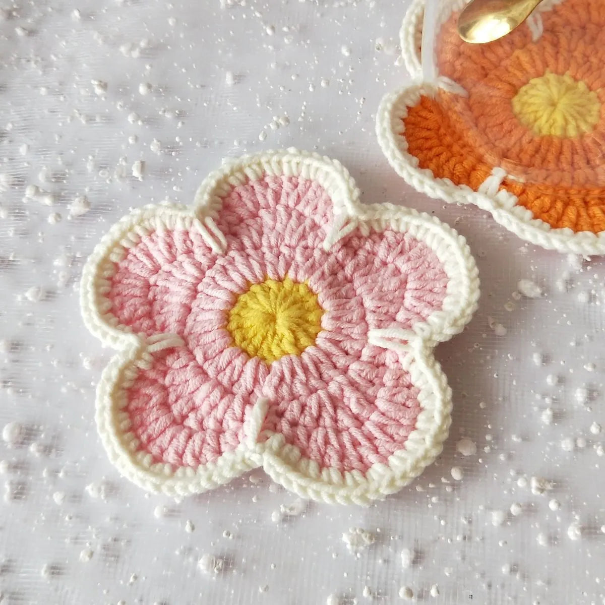 Five handmade woven flower placemats in blue, green, orange, pink and purple colours