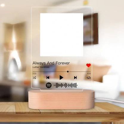 Customisable photo night light with 22x15cm acrylic panel showing engraved song lyrics beside personal photograph