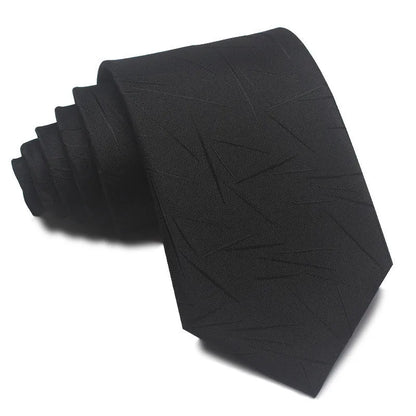 Close-up of a red and black striped jacquard weave tie with an arrow tip, showing texture.