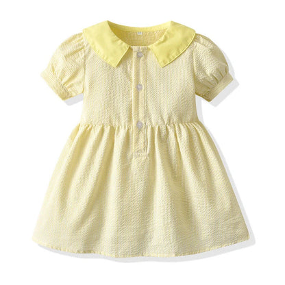 Girl wearing yellow plaid princess cotton dress with matching lace straw hat summer set