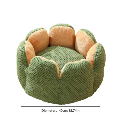 Green cactus petal shape pet bed for cats and dogs on a hardwood floor.