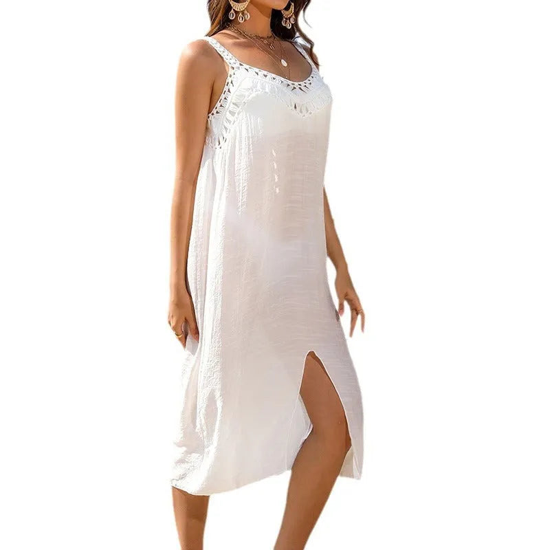 White women's crochet suspender dress with a hollow weave pattern and a high leg slit.