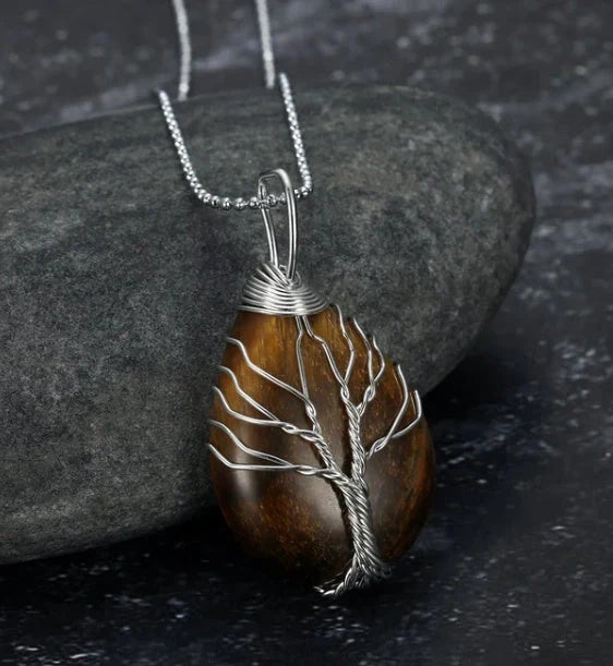 A Celtic Tree of Life pendant necklace made with a teardrop-shaped semi-precious stone and an adjustable chain.