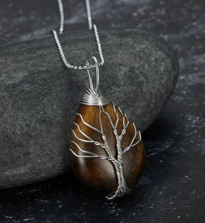 A Celtic Tree of Life pendant necklace made with a teardrop-shaped semi-precious stone and an adjustable chain.