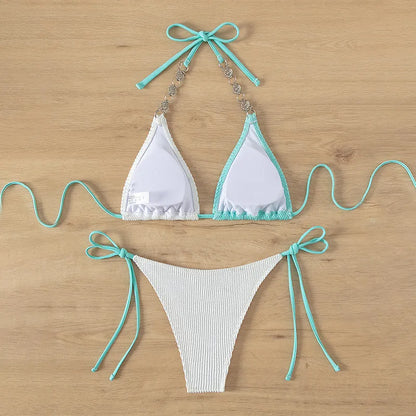 Colour-matched women's lace-up bikini with pearl chain detail on a sleeveless top and shorts.