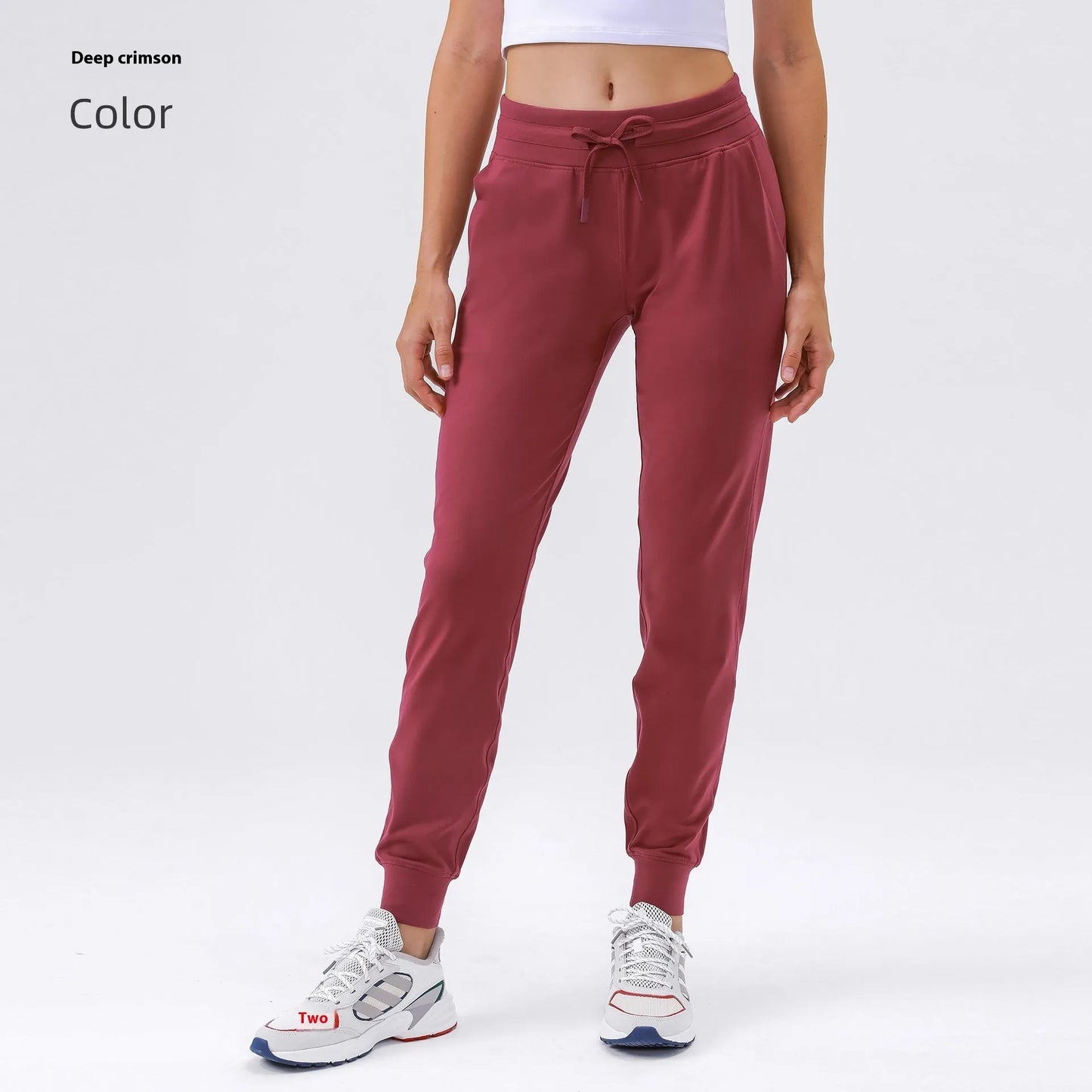 Women's high waist yoga pants with drawstring waistband in Belgian blue colour, showing stretch fabric during yoga pose