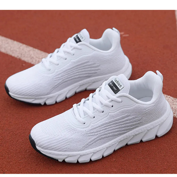 Women's black and white low-top running casual sneakers with MD sole and cross strap detail