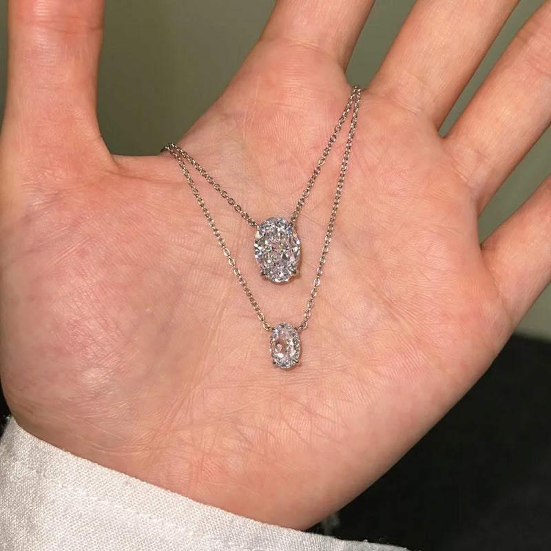 Women's sterling silver necklace in oval pendant design featuring S925 silver construction with choice of platinum or gold plating and two size options of 6x9mm or 9x13mm for geometric style jewellery