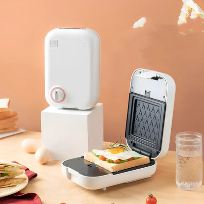 White mini breakfast machine with metal construction measuring 12x11cm for single-person cooking