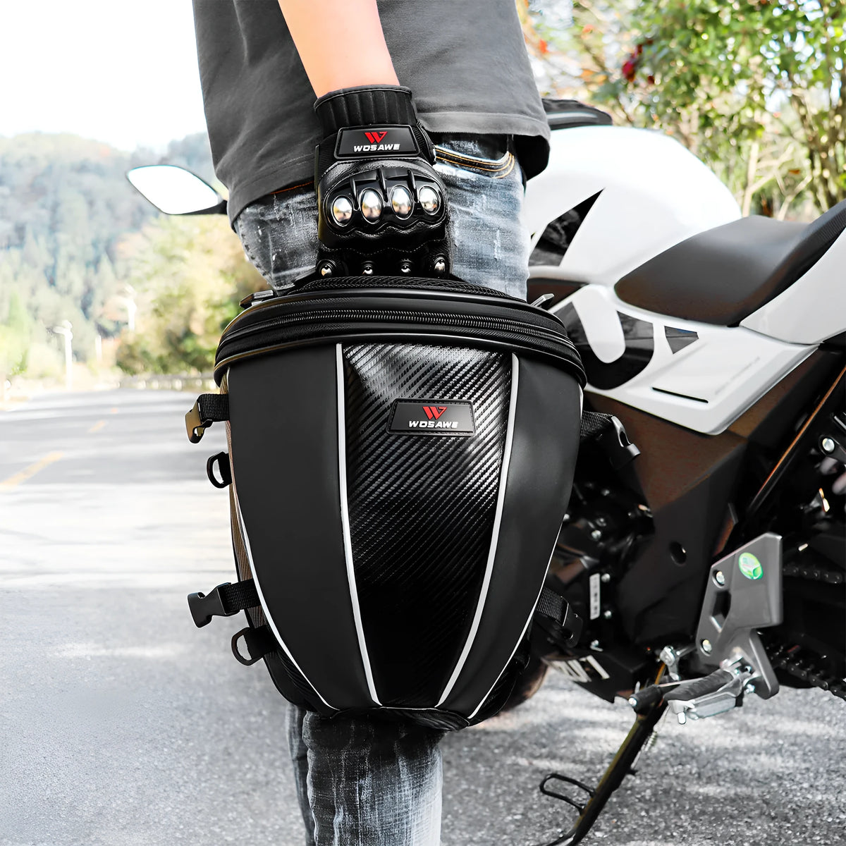 Black waterproof motorcycle tail bag with reflective stripe, showing multiple pockets and a carrying strap.