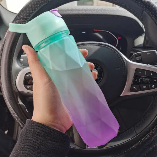 Large plastic spray water bottle with handle strap and leakproof lid in green colour.