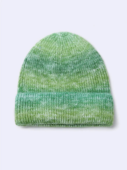 Gradient yarn knitted hat with tapered top in light blue colour showing knitted texture